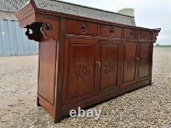 A Impressive Large Chinese Sideboard with Dragon Carvings and Fretwork