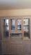 Large wooden display cabinet with glass doors, unbranded wooden